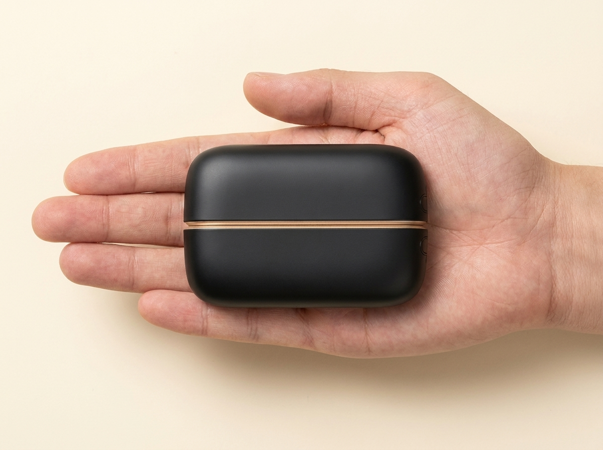 Hand warmer resting in an open palm to show its size